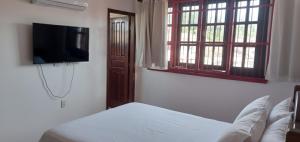 a bedroom with a bed and a flat screen tv at Cop30 in Belém