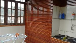 a kitchen with a wooden wall and a sink at Cop30 in Belém
