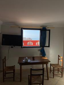 a dining room with a table and a window at Seaview apartment in Mirleft