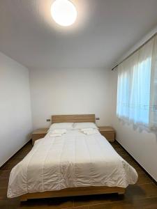 a bedroom with a large bed with a window at Luino Family Retreat in Luino +8 photos