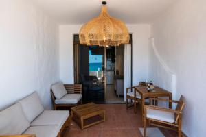 a living room with a couch and a chandelier at Beach & Ocean in Costa Calma
