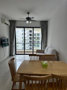 a living room with a table and chairs and a couch at Forest City Homestay 森林民宿 in Gelang Patah