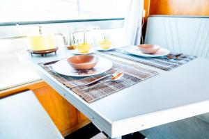 a table with two bowls and plates on it at Spartan Royal Mansion in Tombstone +8 photos