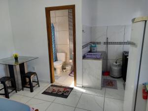 a bathroom with a shower and a toilet and a table at Residencial Caiobá II in Matinhos +35 photos