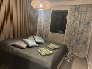 a bedroom with a bed with two towels on it at Apartment for five near Railway station in Rovaniemi