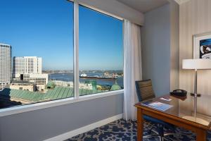 a room with a desk and a large window at Loews New Orleans Hotel in New Orleans