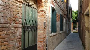een steegje met een deur en een bakstenen gebouw bij Casa sul rio in Venetië