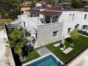 an aerial view of a house with a swimming pool at Golden Gaia Villas in Kipía