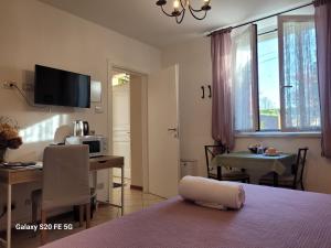 a bedroom with a bed and a desk and a television at La Meridiana Affittacamere in Colorno