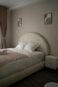 a bedroom with a large bed with a headboard at Hôtel Sofiane in Paris