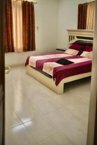 a bedroom with two beds and a window with curtains at السعادة للشقق المفروشة 