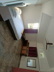 a small room with a bed and a staircase at Saagar's Farmstay in Jalpāiguri
