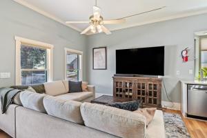 a living room with a couch and a flat screen tv at Copper Queen Retreat in Bisbee
