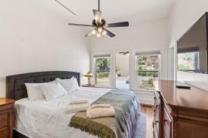 a bedroom with a bed and a ceiling fan at Copper Queen Retreat in Bisbee +11 photos