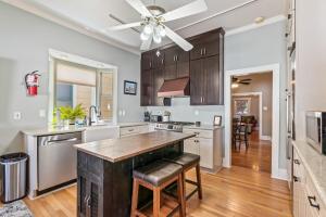 a kitchen with wooden cabinets and a ceiling fan at Copper Queen Retreat in Bisbee