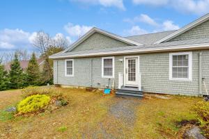 a gray house with a yard in front of it at The View II at Sheepscot River in Fort Edgecomb