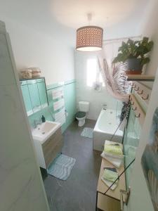 RiaにあるMaison 4 pers avec jardin au pied des montagnesの洗面台、トイレ、鏡のあるバスルーム +9枚の写真