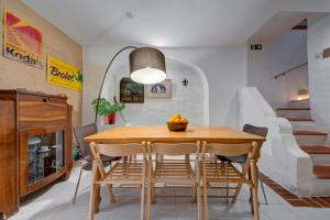 a dining room with a wooden table and chairs at Villa Josette with Pool Table and Garden by Haven and Keys Malta in Tal-Għoqod