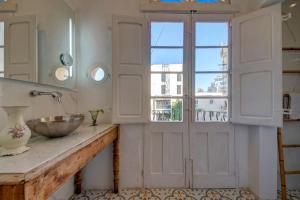 a bathroom with a sink and a window at Villa Josette with Pool Table and Garden by Haven and Keys Malta in Tal-Għoqod +62 photos