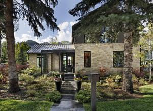 a stone house with a walkway in front of it at Elegant Aspen Chalet Steps to Gondola in Aspen