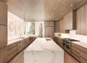 a kitchen with a large marble counter top in it at Elegant Aspen Chalet Steps to Gondola in Aspen +24 photos