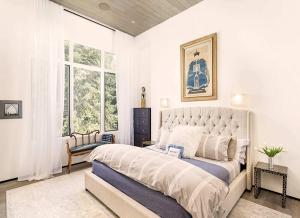 a bedroom with a large bed and a window at Elegant Aspen Chalet Steps to Gondola in Aspen