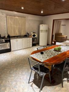 a kitchen with a table with chairs and a refrigerator at Casa bulgara boutique in Aristóbulo del Valle