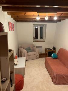 a living room with a couch and a chair at Le Duplex de Léa in Valenciennes
