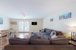 a living room with a couch and a table at The View III at Sheepscot River in Fort Edgecomb