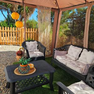 a patio with two couches and a table at Cortijo El Ancla in Albox