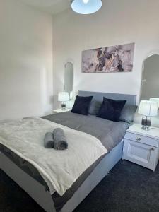 a bedroom with a large bed with two night stands at Comfort in the East in Glasgow