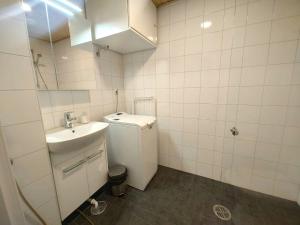 a white bathroom with a sink and a toilet at Convenient Studio for 1 in Masala