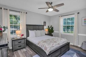 a bedroom with a bed and a ceiling fan at Lexington Leisure House- 4BR in Lexington +48 photos