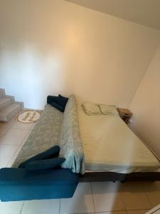 a large bed with blue pillows in a room at Cristian in Livry-Gargan