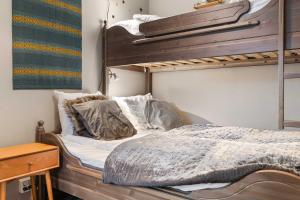 a bedroom with two bunk beds and a desk at TH963- Cozy Ski-in out apartment in Trysil in Trysil +9 photos