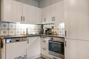 a white kitchen with white cabinets and appliances at TH963- Cozy Ski-in out apartment in Trysil in Trysil