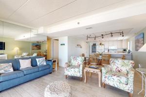 a living room with a blue couch and chairs at Waikiki 406 in Ocean City