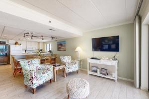 a living room with a kitchen and a dining room at Waikiki 406 in Ocean City