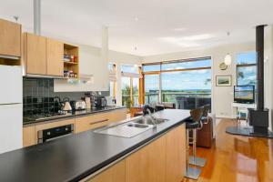 a kitchen with a sink and a counter top at Sunrise By The Sea in Torquay