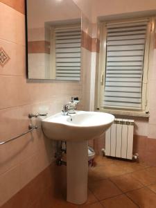 a bathroom with a white sink and a mirror at Tetto Verde in Carolei +25 photos