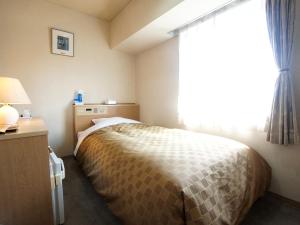 Postel nebo postele na pokoji v ubytování Hotel Trend Nagano