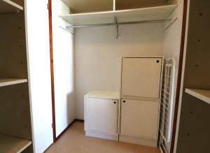 a small kitchen with a refrigerator and shelves at Central and Spacious Apartment for 4 with Sauna in Kirkkonummi +4 photos