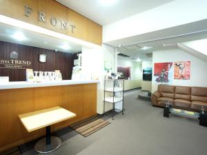 a room with a store with a couch and a counter at Hotel Trend Nagano in Nagano