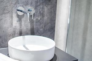 a bathroom with a white sink and a shower at Once-in-a-Lifetime Escape Celestine Hot Tub Between Two State Parks in Pipestem +31 photos