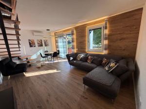 a living room with a couch and a table at Il giardino dei larici in Selvino +7 photos