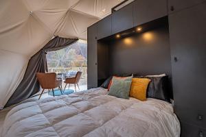 a bedroom with a large bed in a tent at Once-in-a-Lifetime Escape Celestine Hot Tub Between Two State Parks in Pipestem
