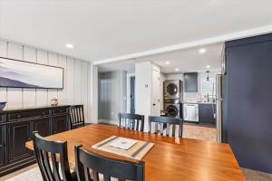a kitchen and dining room with a wooden table and chairs at Village Green 9F in Stowe +28 photos