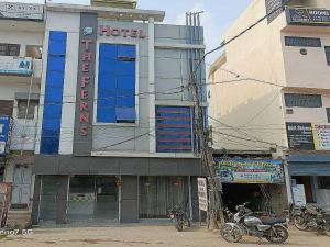 a hotel building with motorcycles parked in front of it at Hotel O The Ferns in Thānesar