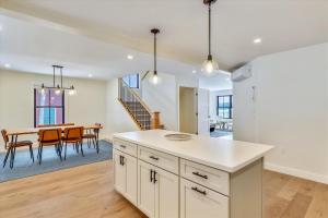 an open kitchen and dining room with a table at Village with a View in Stowe