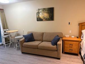 a living room with a couch and a table at Oceanside Getaway in Nanoose Bay